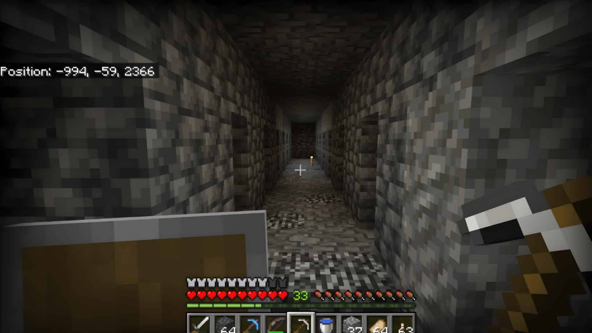 Branch mining tunnel at Y level -59 with coordinates shown in Minecraft Bedrock. (1)